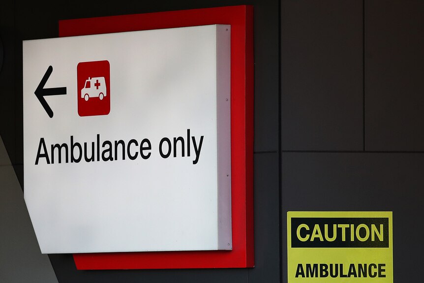 a large sign with an arrow that says 'ambulance only'