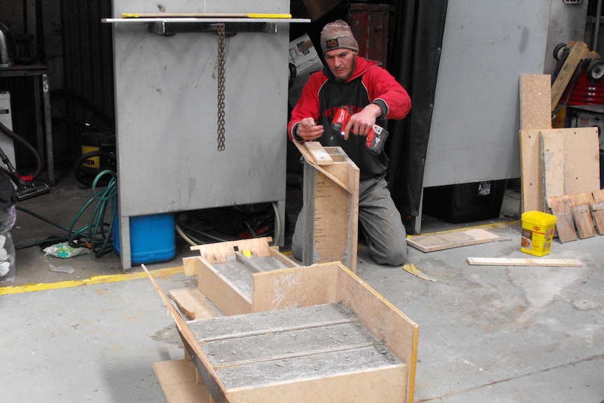 Stephen Callow making grave stone markers