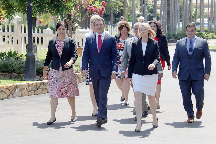 NT Chief Minister Michael Gunner (front in red tie) walks to Government House with his cabinet