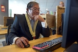 Cambodian minister of Information and government spokesman Khieu Kanharith looks at a computer