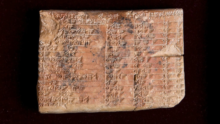 A closeup of a clay tablet covered in cuneiform script.