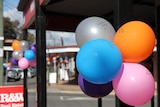 balloons on post and in background in street shot