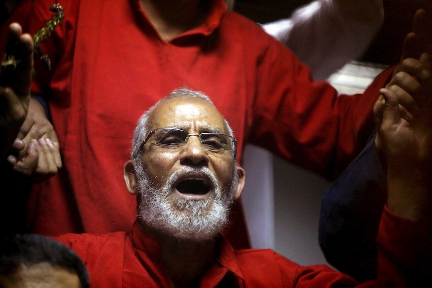 Mohamed Badie shouts in court
