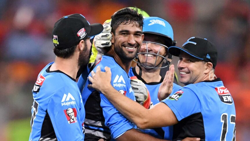 Ish Sodhi (centre) of the Strikers is congratulated by 5 of his teammates
