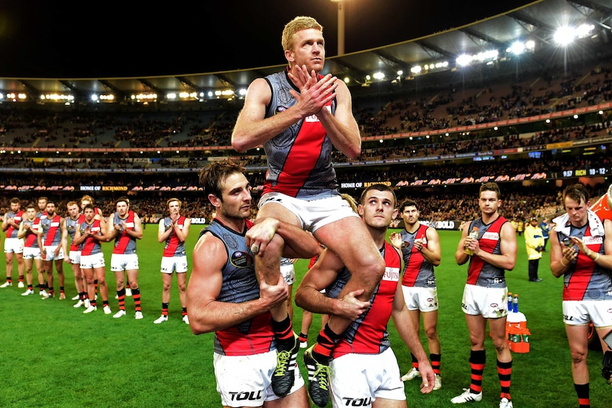 Essendon's Dustin Fletcher is chaired off the ground after his 400th AFL game for the Bombers