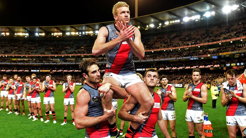 Essendon's Dustin Fletcher is chaired off the ground after his 400th AFL game for the Bombers