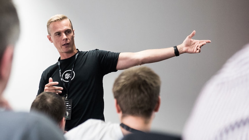 Security researcher Troy Hunt gestures during a presentation.