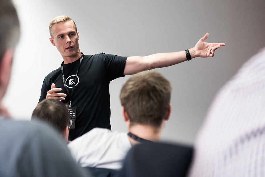 Security researcher Troy Hunt gestures during a presentation.
