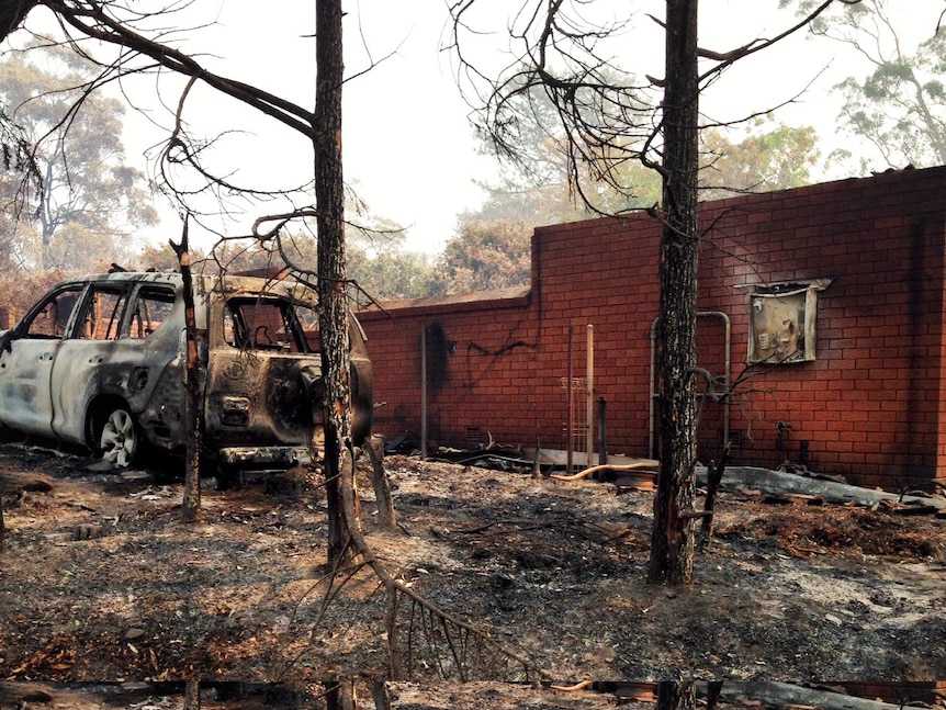 The burnt remains of a car and house at Winmalee.