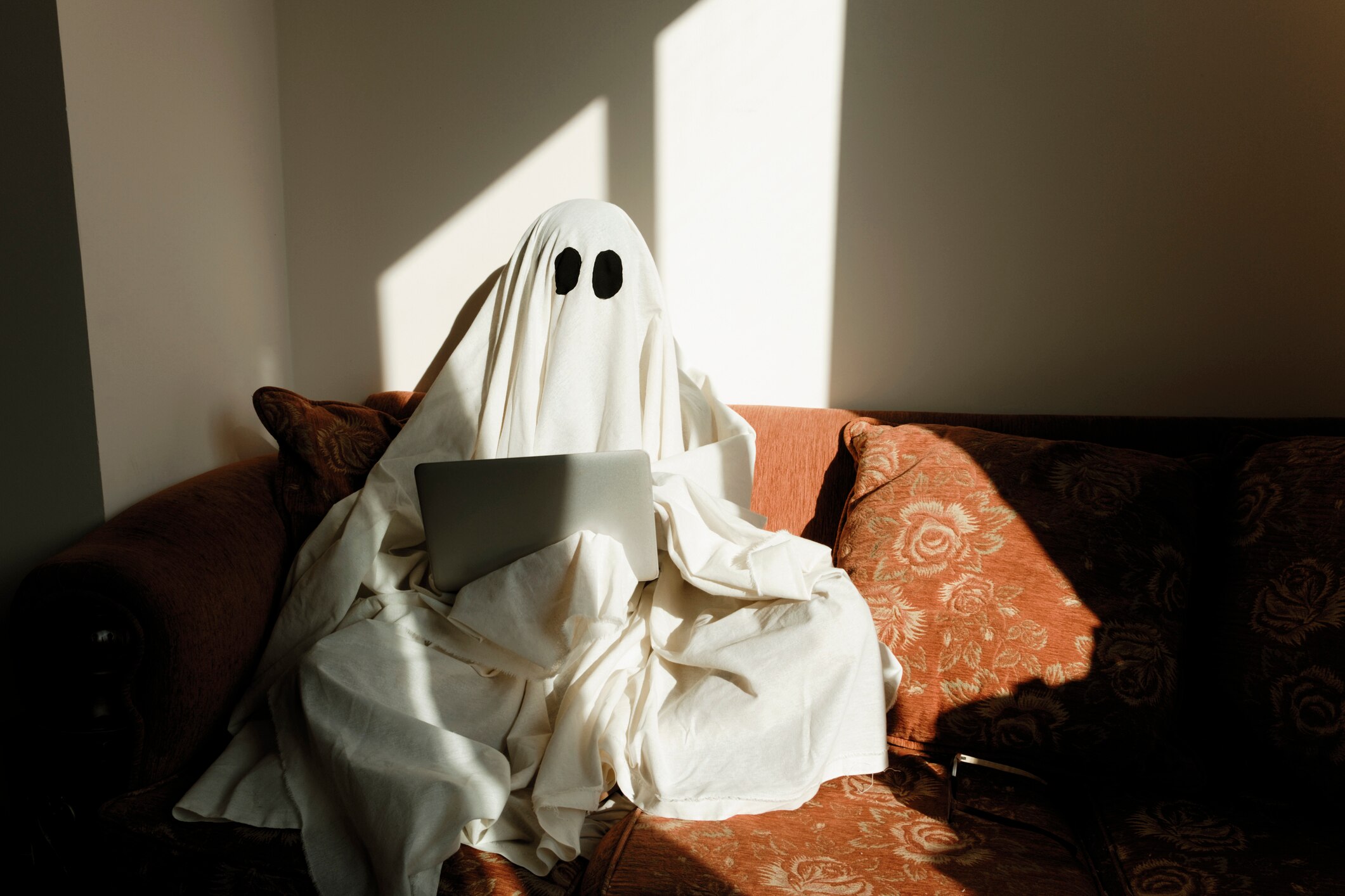 A person with a white sheet over them to look like a ghost