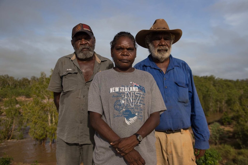 Casey Davis, Josie Davey Green and Jack Green stand on the McArthur River crossing bridge.