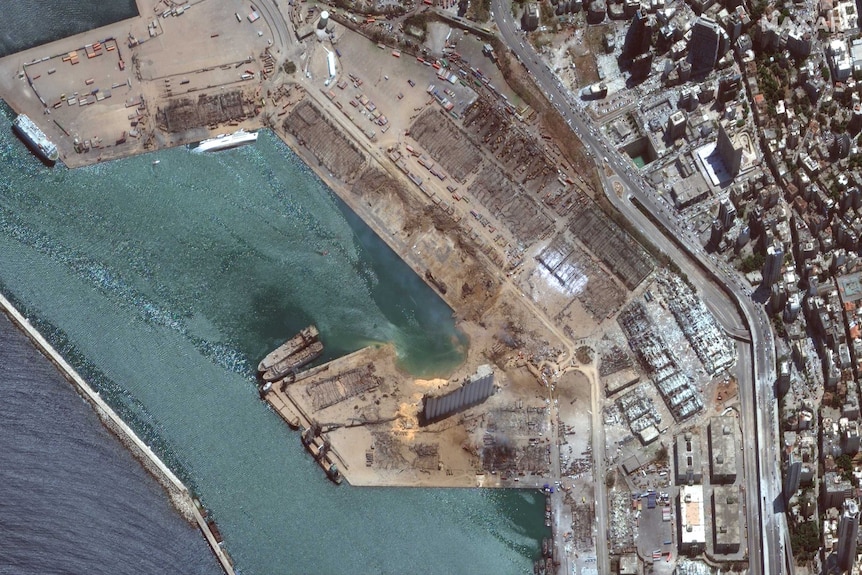 A satellite photo shows destruction, a capsized ship and destroyed buildings in Beirut's harbour after the explosion