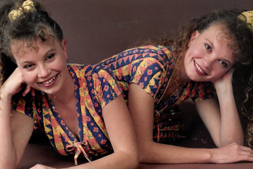 Twin girls in colourful activewear posing for photograph