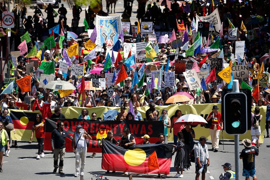 Extinction Rebellion activists march during Brisbane Rebellion Week at South Brisbane.