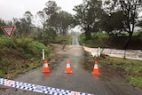 Police tape at flooded causeway where a car was swept away near Gympie on evening of October 16, 2017