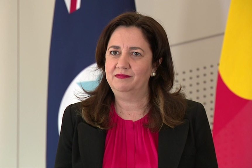 Dark haired woman in red top and black jacket