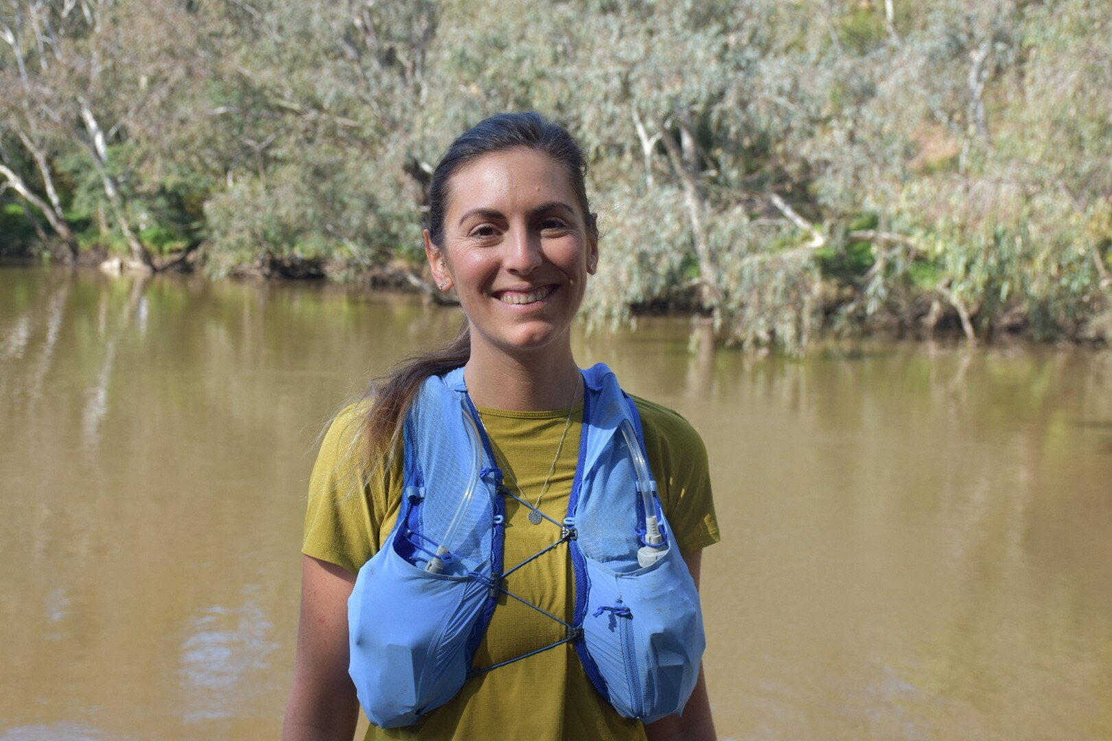 Karin Traeger, wearing marathon gear, smiles at the camera.