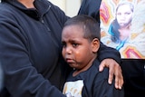Her son cries as he is held by his mother following the verdict.