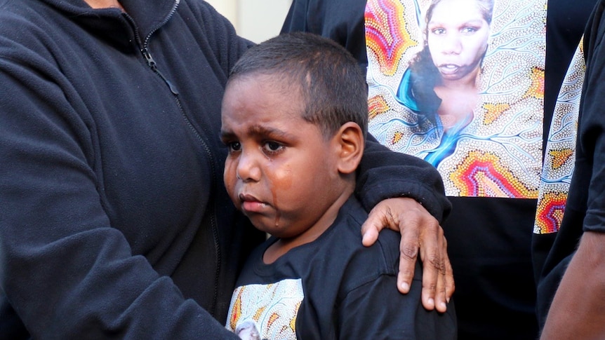 Her son cries as he is held by his mother following the verdict.
