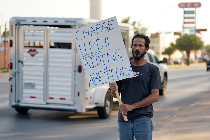 A Uvalde resident protesting on the street 