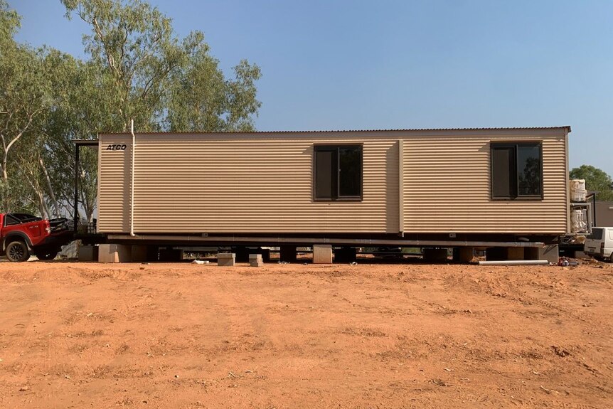 A transportable building on a dry block of land.