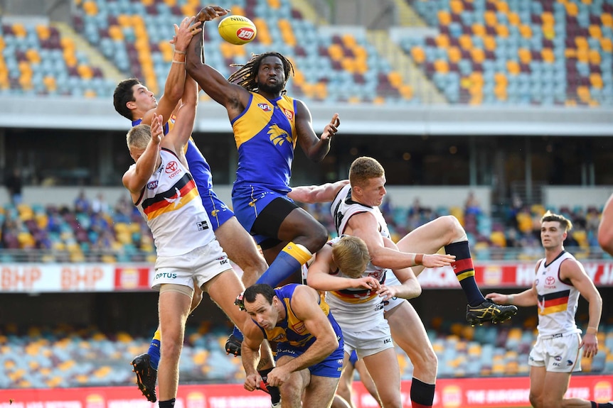 Nic Naitanui gets a ride above a large pack of players, including Adelaide's Reilly O'Brien