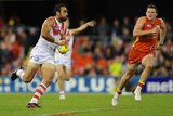 On song ... Adam Goodes moves the Swans forward in attack