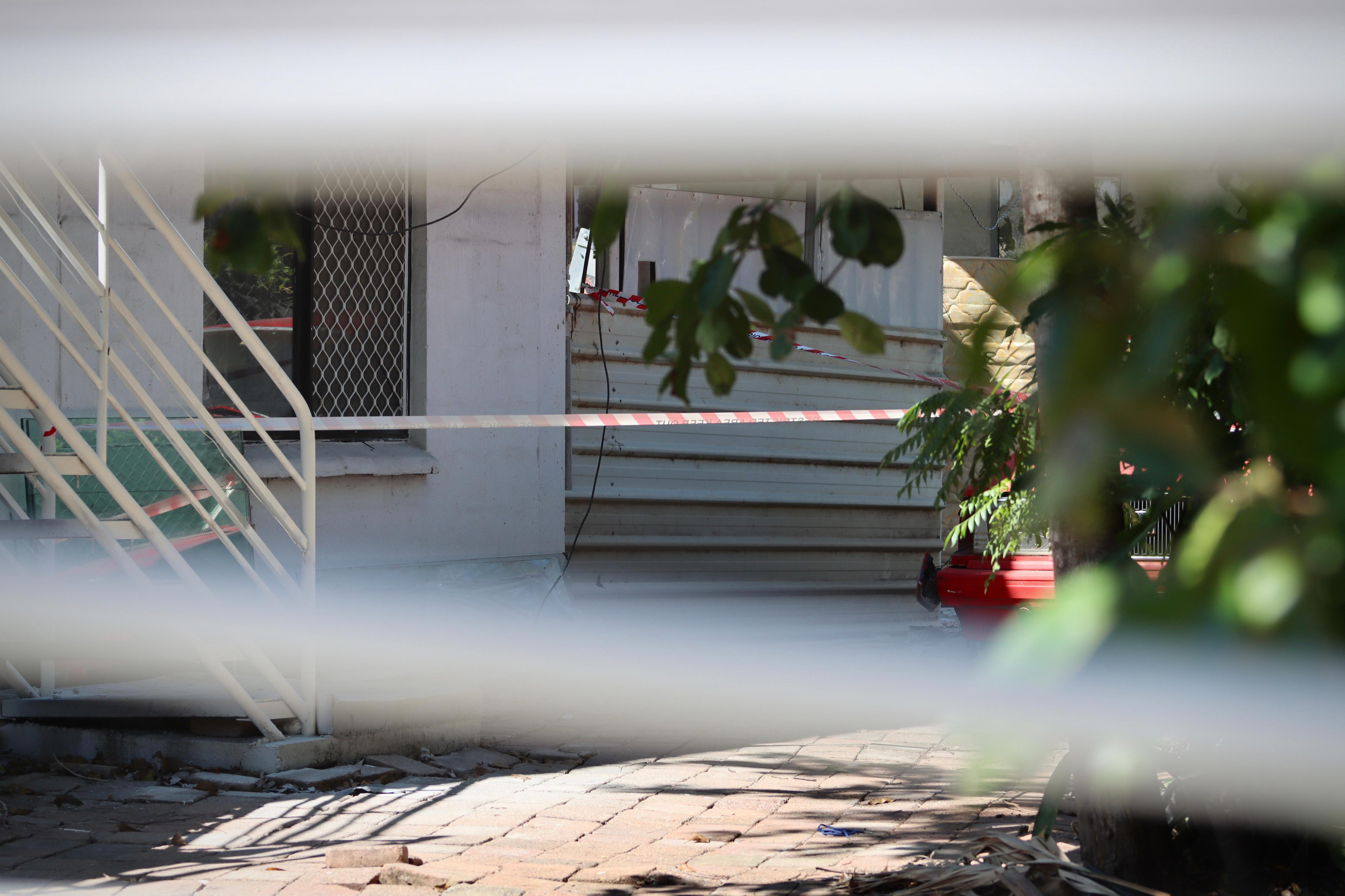 Police crime scene tape outside a house.