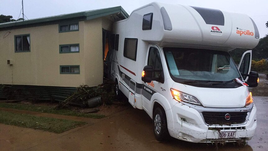 A motorhome wedged up against a caravan annexe after the Cairns caravan park was flooded.