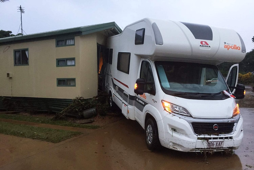 A motorhome wedged up against a caravan annexe after the Cairns caravan park was flooded.