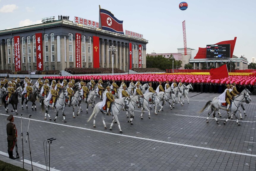 Soldiers ride horses past a stand with North Korean leader Kim Jong Un during the parade celebrating the 70th anniversary of the founding of the ruling Workers' Party of Korea, in Pyongyang, October 10, 2015.