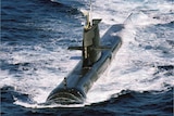 Aerial view of HMAS Sheean ploughing throw the waves.