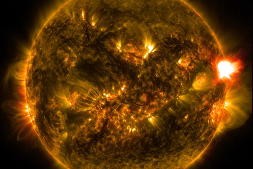 The disk of the Sun with a bright solar flare erupting