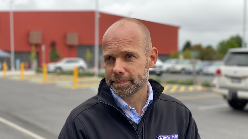 Man standing in front of testing site in Traralgon 