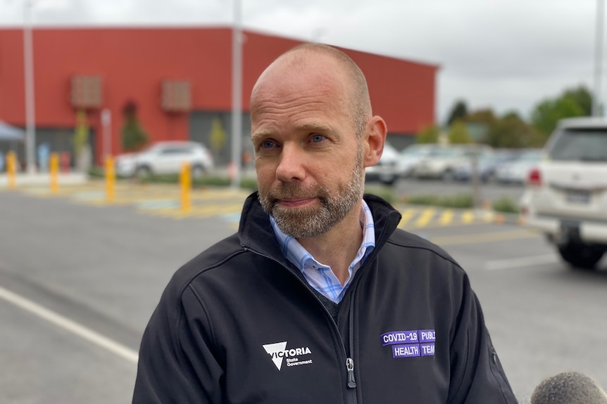 Man standing in front of testing site in Traralgon 