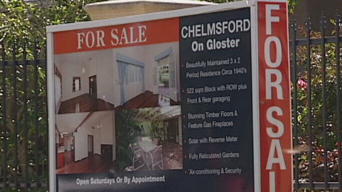 A 'for sale' sign outside a house