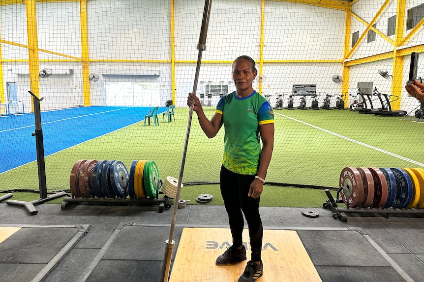 A woman weightlifter holding a bar