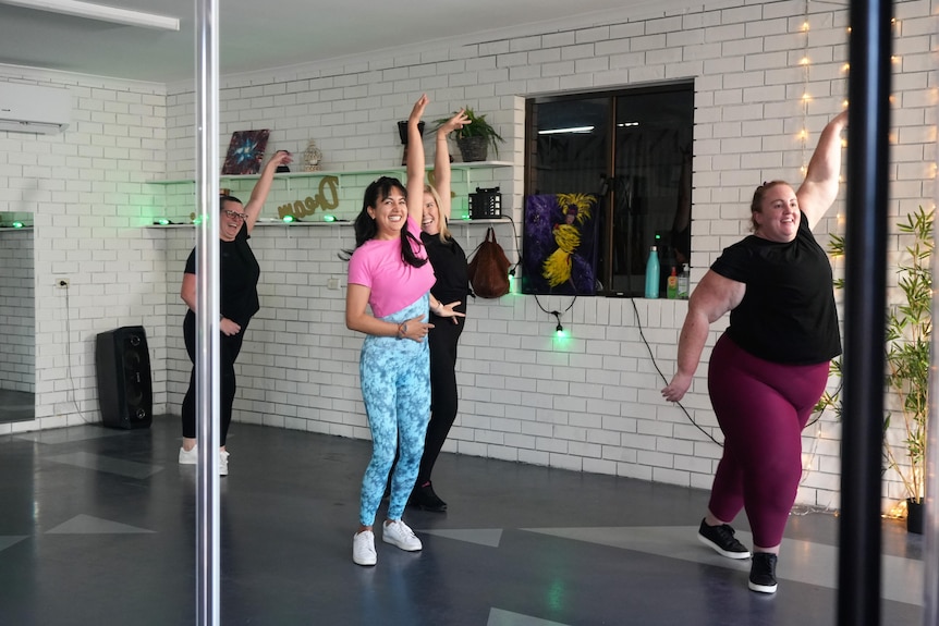 Four women dance in a studio