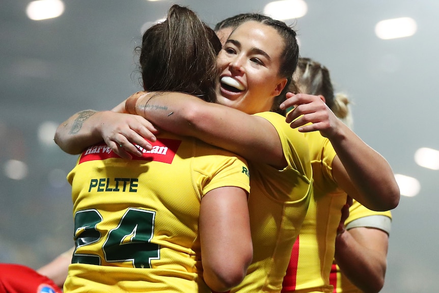 Isabelle Kelly hugs Evania Pelite after a try against Papua New Guinea in the Jillaroos' Rugby League World Cup semifinal.