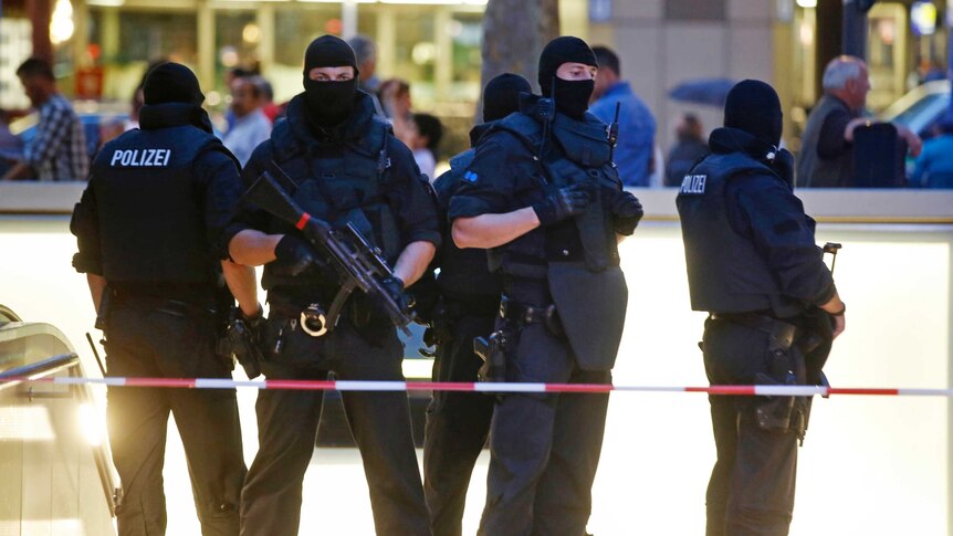 Special forces police officers stand guard at a Munich train station