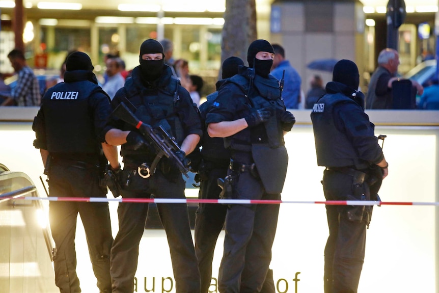 Special forces police officers stand guard at a Munich train station