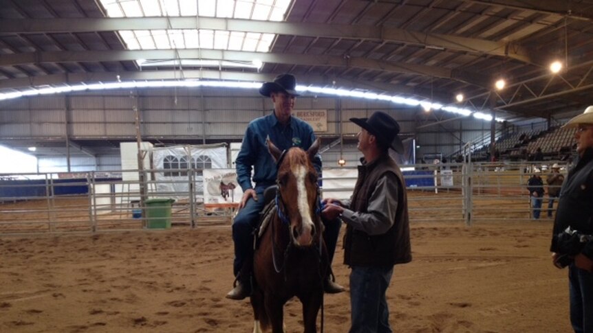 Oakey rider Todd Graham is presented with a blue ribbon at the Toowoomba Futurity held at the showgrounds.