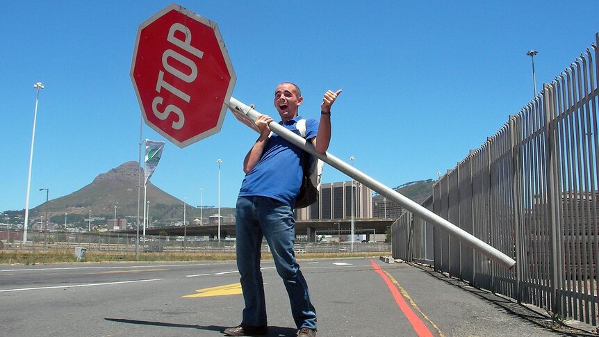 Jeremy uses a stop sign to catch drivers' attention in South Africa.