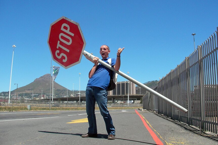 Jeremy uses a stop sign to catch drivers' attention in South Africa.