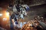 A claw scoops up garbage at an incinerator