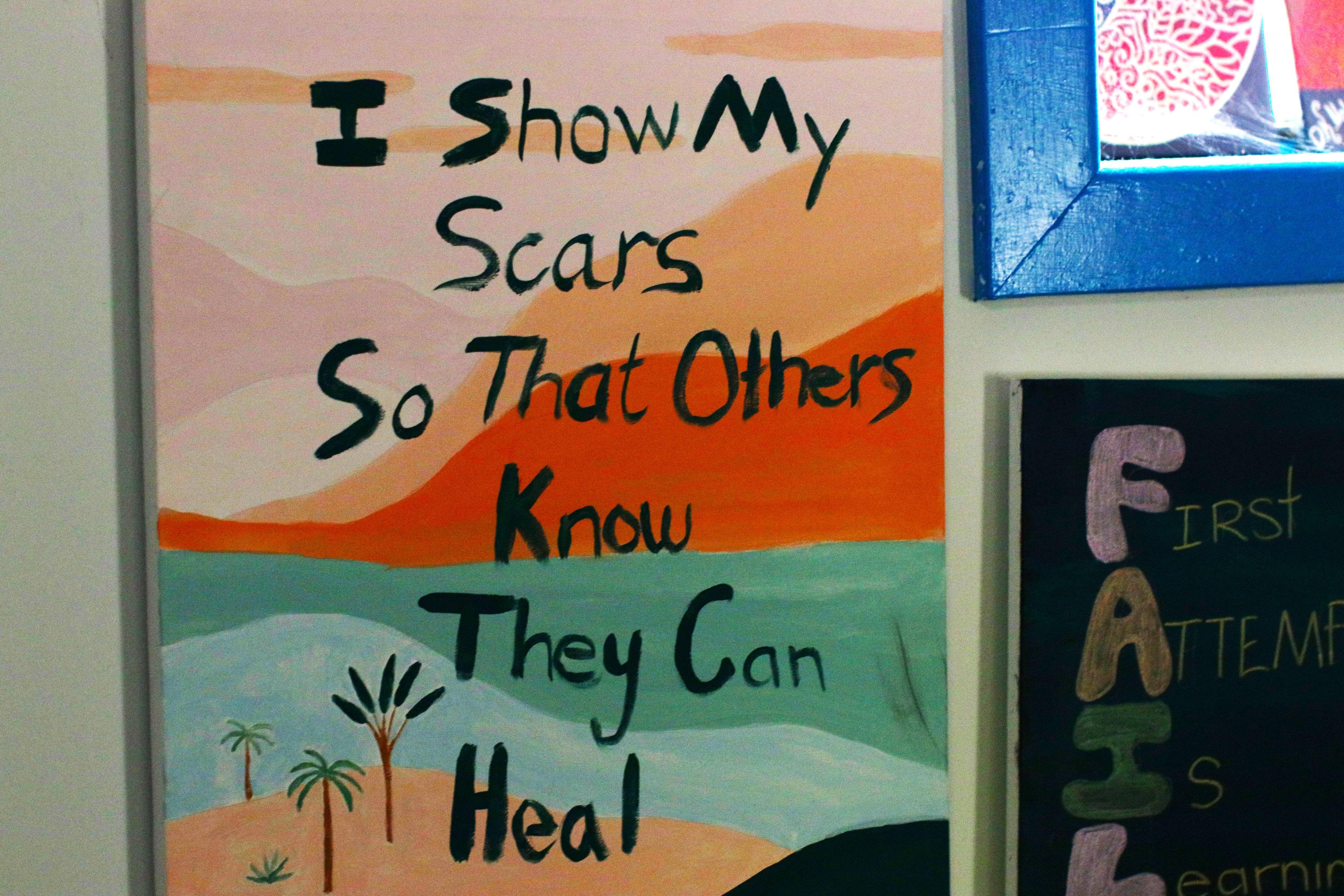 Colourful meme painted about showing scars so others can heal