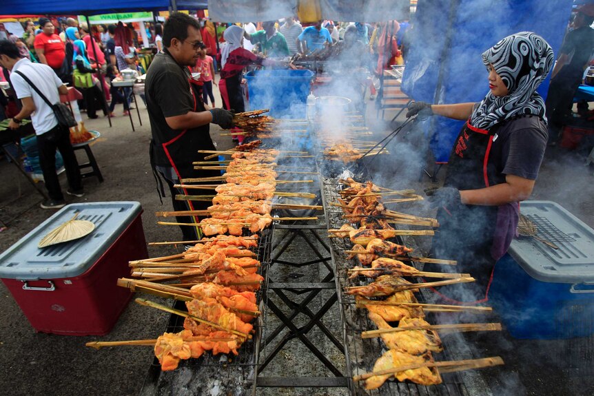 Muslim vendors prepare local dish at a Ramadan market near Kuala Lumpur.