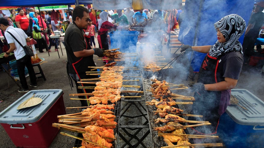 Muslim vendors prepare local dish at a Ramadan market near Kuala Lumpur.