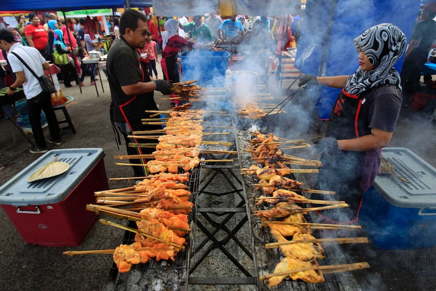 Muslim vendors prepare local dish at a Ramadan market near Kuala Lumpur.