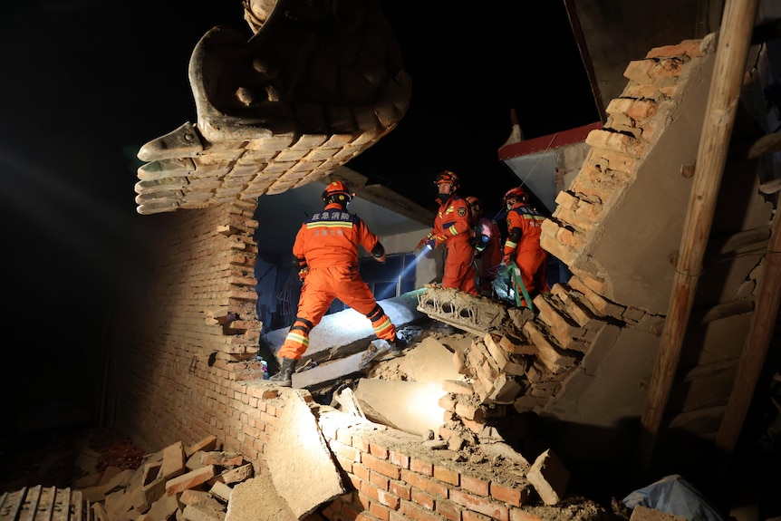 Rescuers work on the rubble of a house that collapsed in the earthquake.